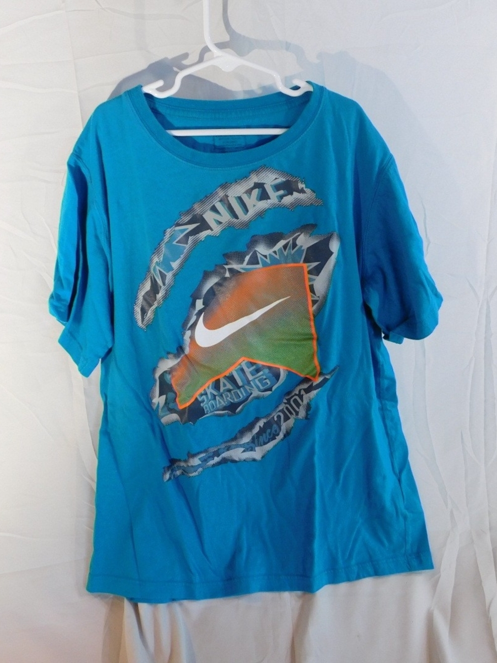 Nike Blue Short Sleeve Graphic Tee with Orange Accent